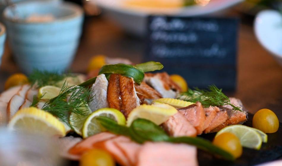 Selection of smoked and fresh fish at the breakfast buffet in the Vju Hotel Rügen with lemons and dill.