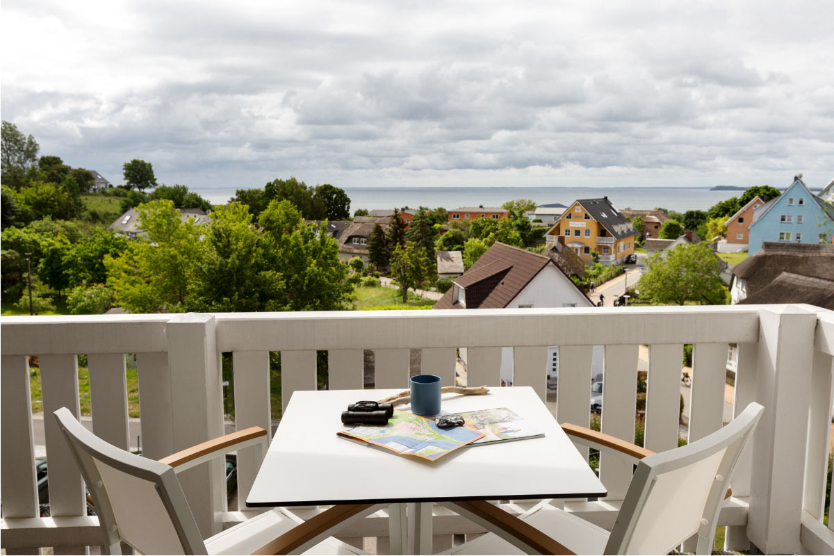 Balcony of the comfort double room with table, chairs and wonderful view of the Baltic Sea at the Koopmanns Hotel.