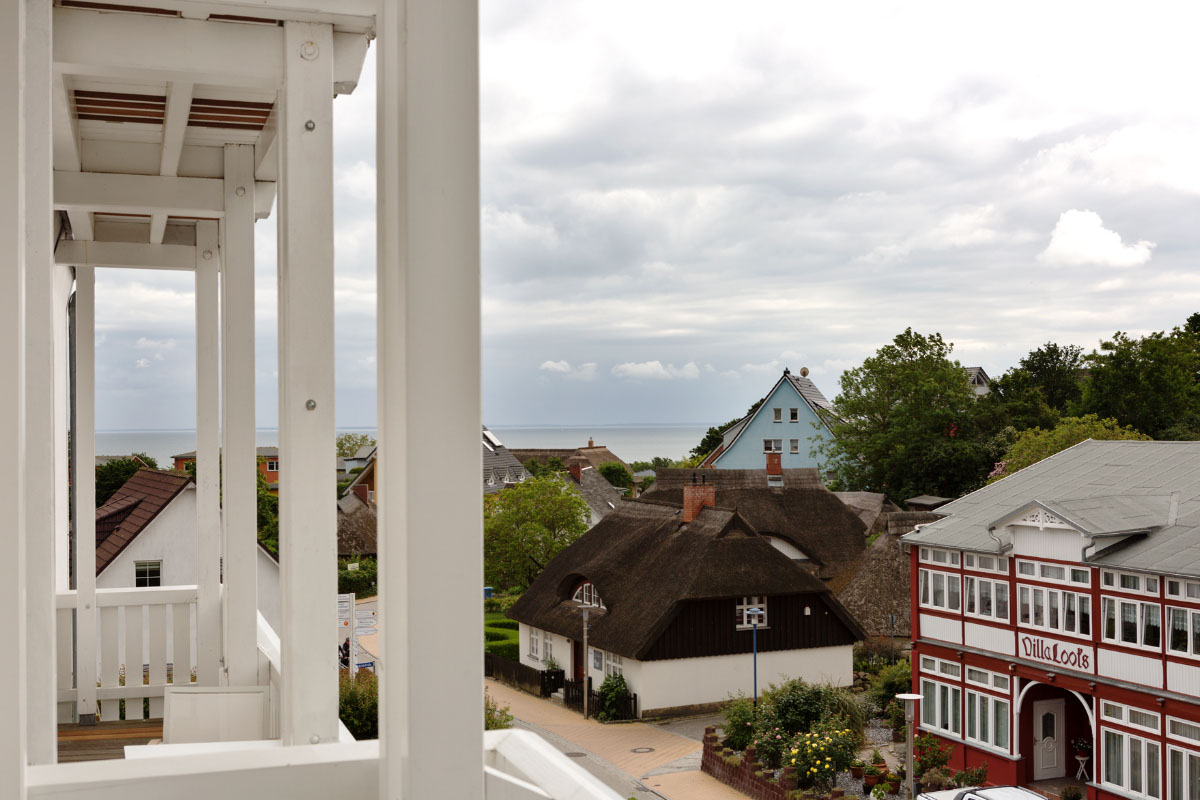 View of thatched roofs, traditional houses in Göhren and the Baltic Sea from the balcony of a single room at the Koopmanns Hotel.